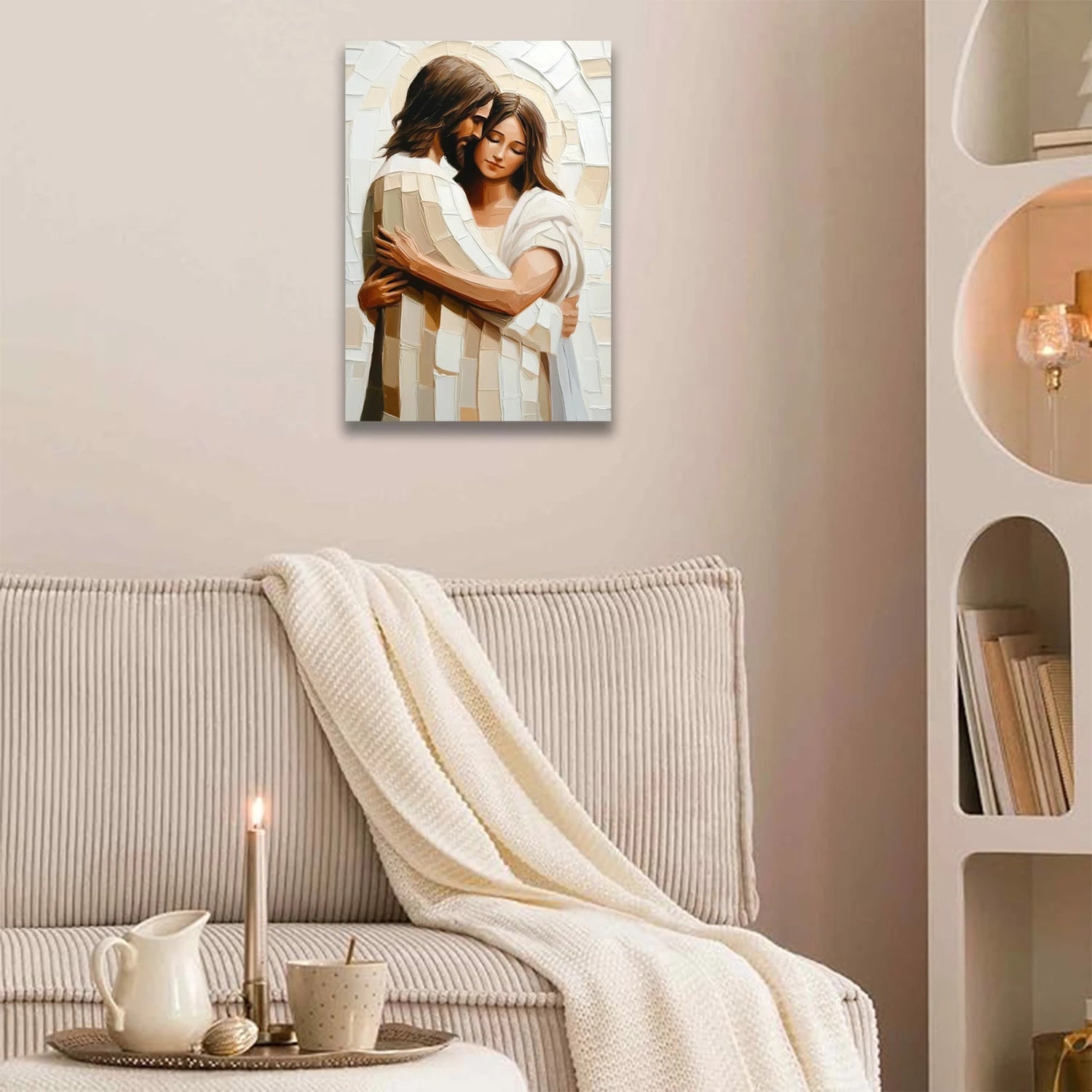 Faith-inspired art piece depicting a couple embracing in soft neutral tones hanging above beige couch with cozy blanket