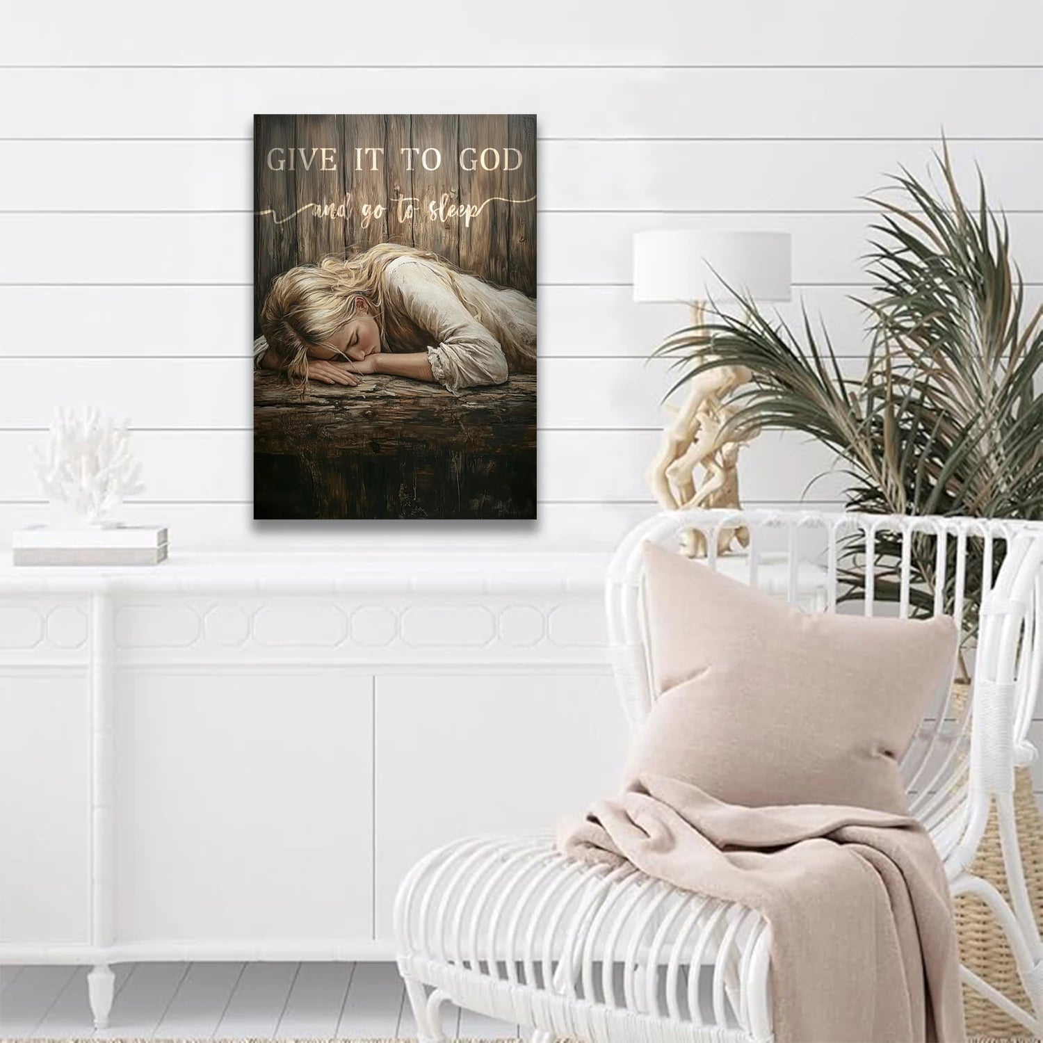 Give It to God wall art featuring a peaceful sleeping woman on a rustic wood background in a modern white living room